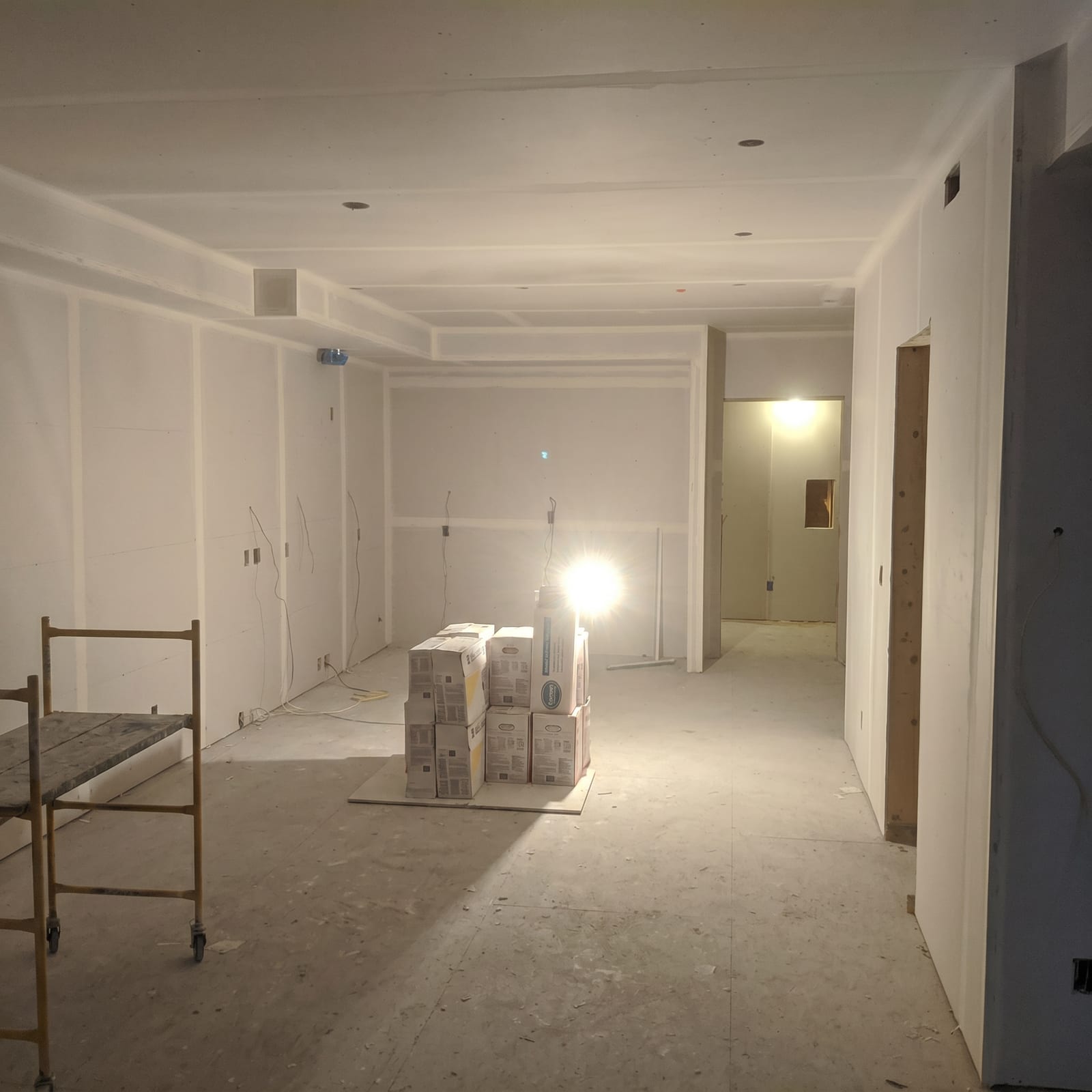 Hallway with finished drywall and two new door openings.