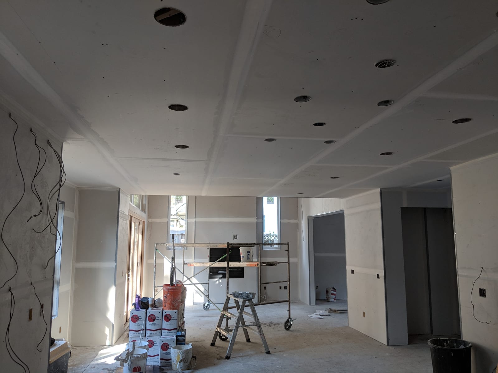 Corner taping underway, light streaming through the windows.