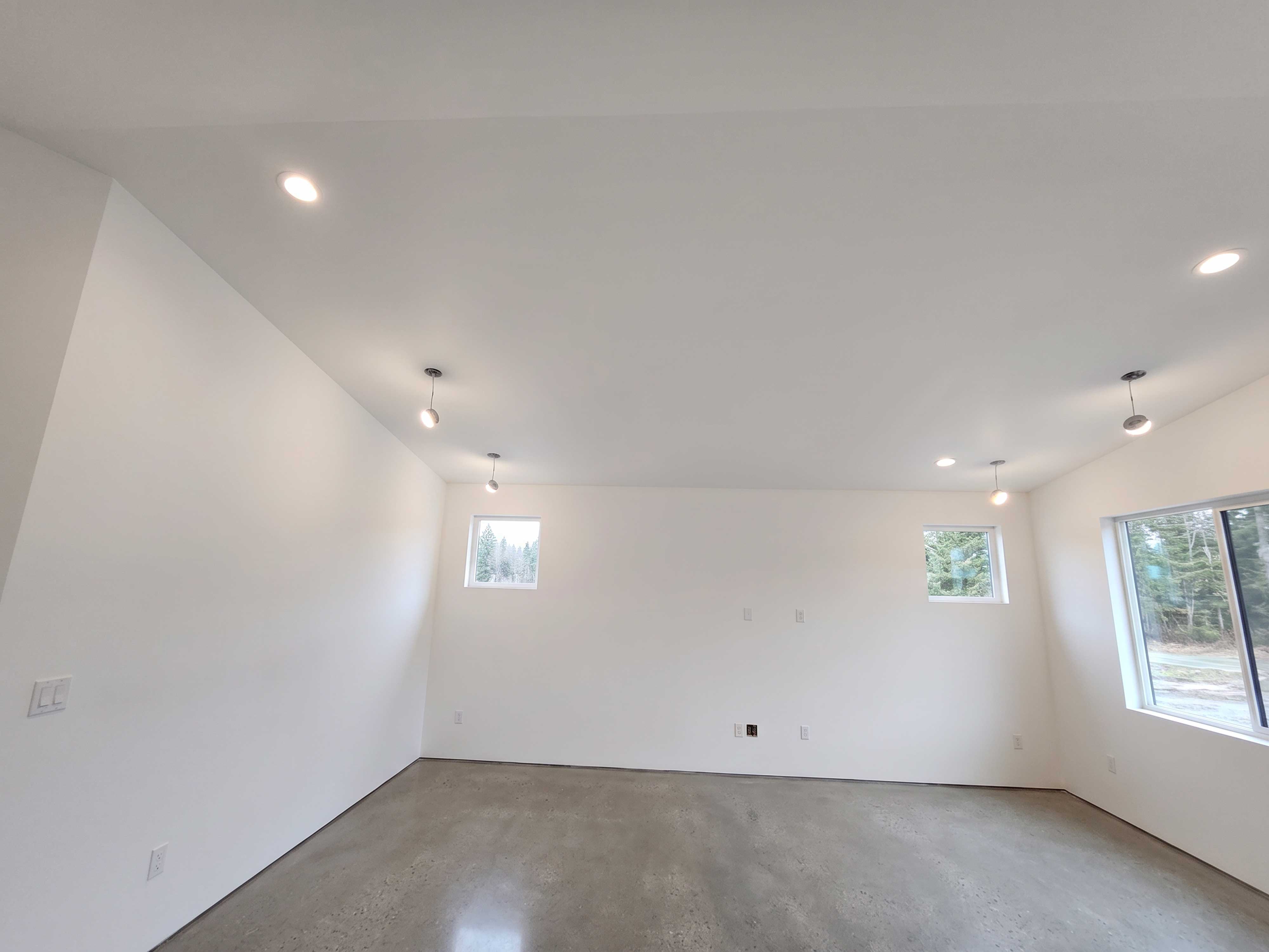 The same room after drywall finishing and painting — smooth, bright, ready for move-in.